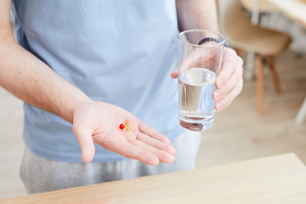 Man drinking vitamin pill